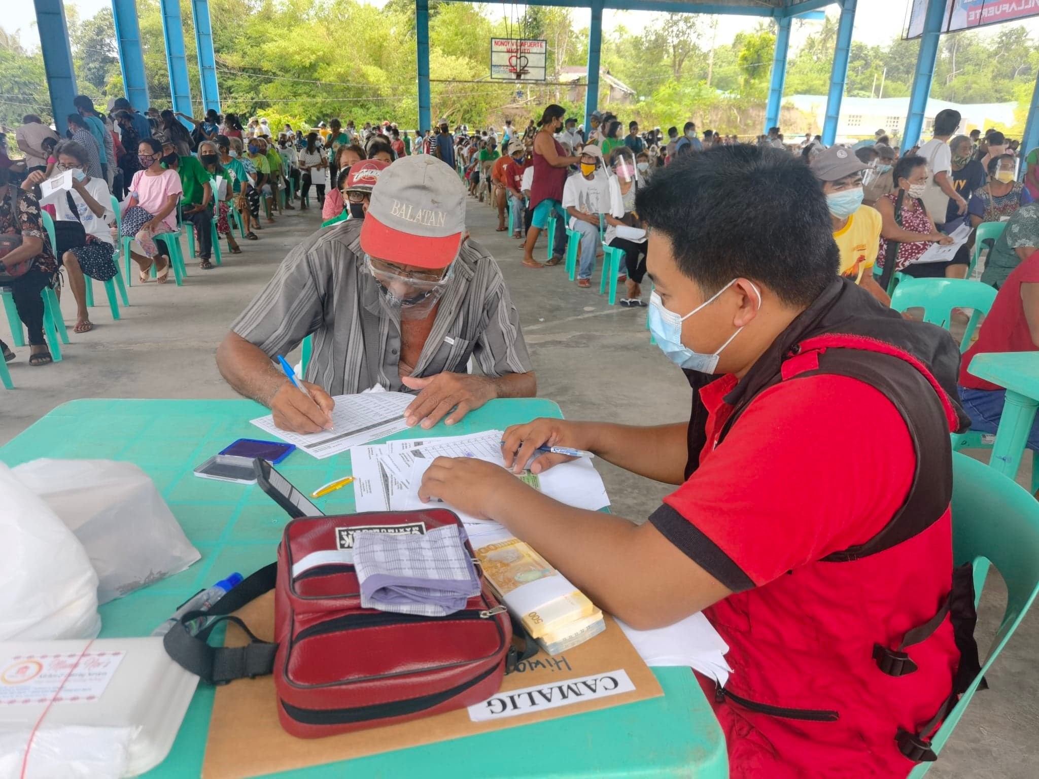 DSWD personnel facilitates release of stipend to indigent senior citizens of Goa, Camarines Sur.